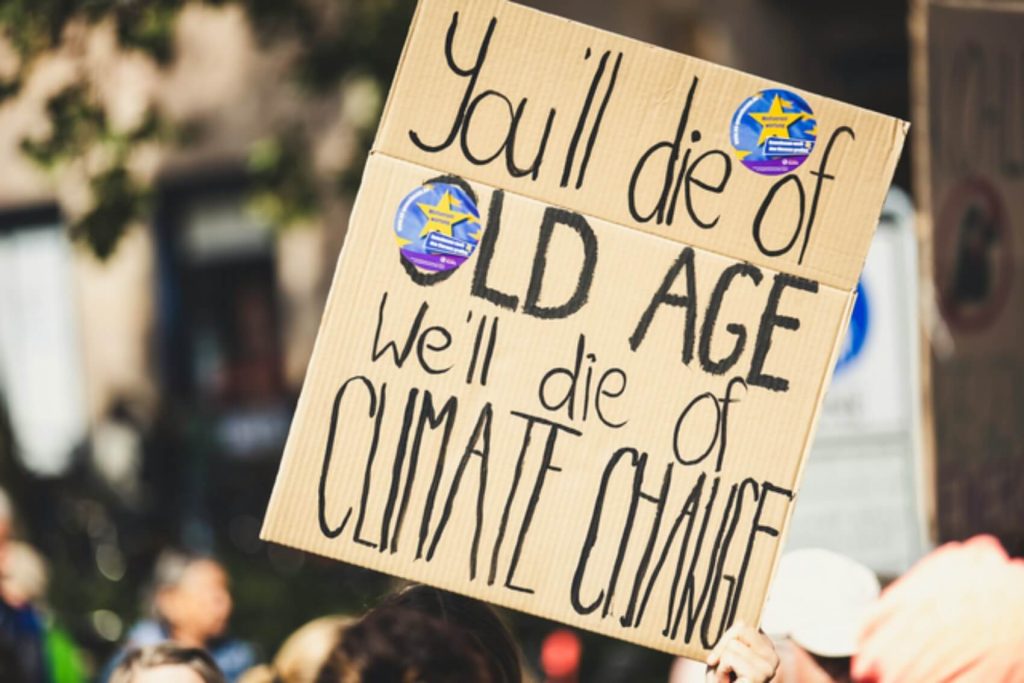 Protest sign about climate change urgency.